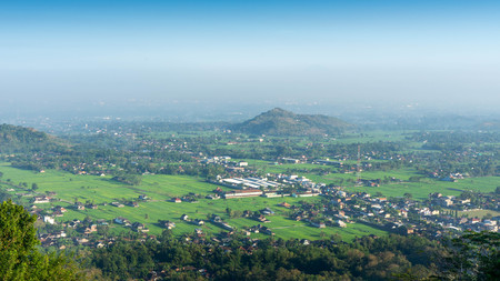 Aerial city view from a hill in the morning with a blue sky backgroundの写真素材