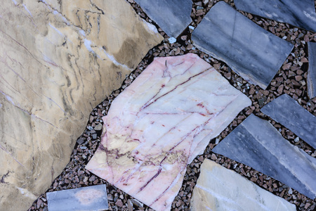 Concrete floor with multi-colored marble stone slabs background and texture