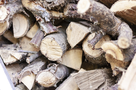 A pile of stacked firewood for the winter - preparation for heating the house