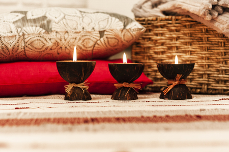 Burning spa aroma candles in coconut shellの写真素材