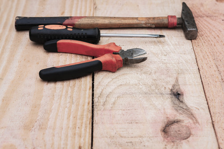 Set of vintage hand construction tools on a wooden background