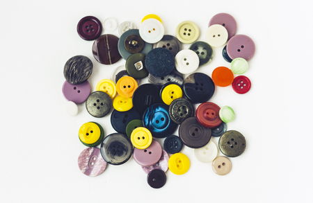 Colorful sewing buttons on white background closeup.