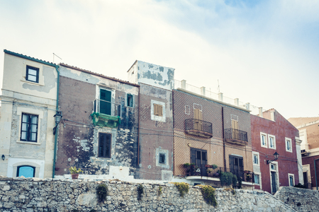 View of old street, facades of ancient buildings in seafront of Ortygia (Ortigia) Island, Syracuse, Sicily, Italyの写真素材