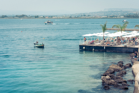 Syracuse, Sicily, Italy â august 12, 2018: people relax on the beach of Ortygia (Ortigia) Islandのeditorial素材