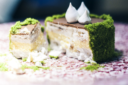 cake with meringue and cream custard on the red plate in restaurant