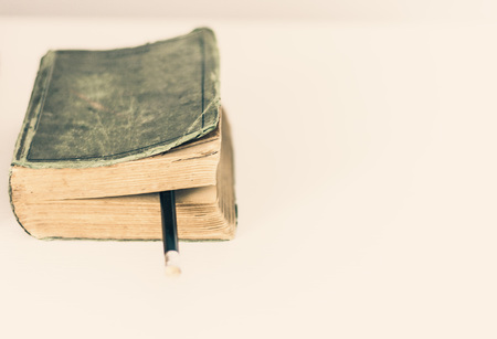 old book on white table, background for education retro conceptの写真素材