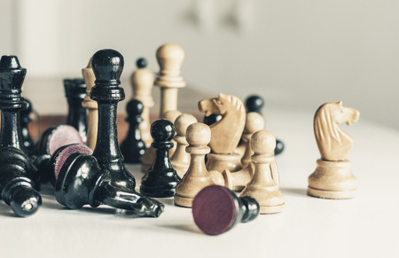 Old well used wooden chess pieces, retro leadership concept on white backgroundの写真素材