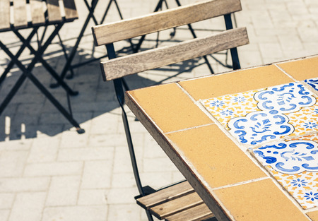 Table and chairs in an outdoor cafe in Syracuse (Siracusa) Sicily
