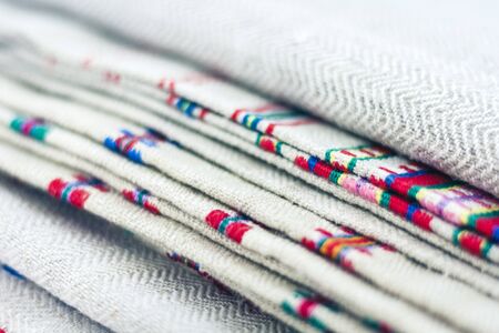 A stack of woven linen towels with embroidery, traditional handmade in Ukraineの写真素材