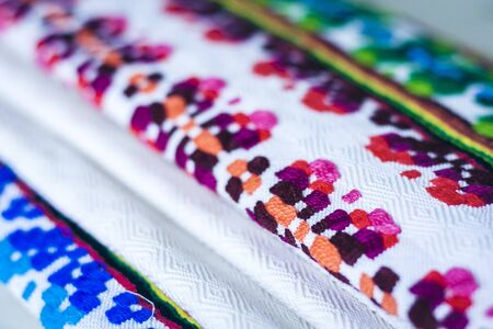 A stack of woven linen towels with embroidery, traditional handmade in Ukraine