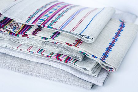 A stack of woven linen towels with embroidery, traditional handmade in Ukraineの写真素材
