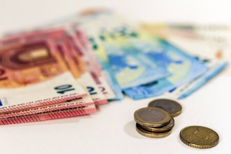 Close up money euro banknotes and coins on white backgroundの写真素材