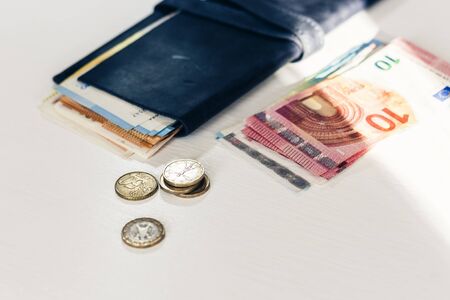 Close up money euro banknotes in blue purse and coins on white backgroundの写真素材