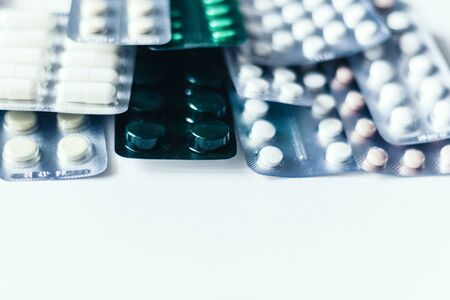 Medicine pills or capsules blister pack on white background with copy space. Drug prescription for...