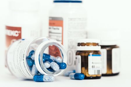 Medicine pills or capsules and bottles on white background with copy space. Drug prescription for treatment medication closeup top viewの写真素材
