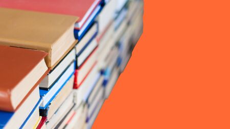 stack of book on red orange lush lava background, education concept, back to school, many books piles with copy space for textの写真素材