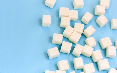 Sugar addiction, insulin resistance, unhealthy diet, sugar cubes on blue background, diabetes...