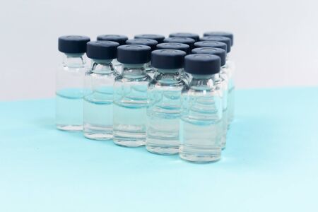 Medicine in vials, ready for vaccine injection on blue background. Cancer, painand diabetes...