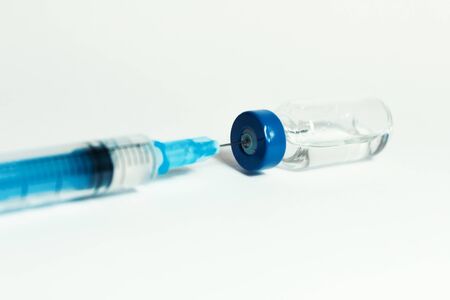 Glass medicine bottle with vaccine injection fluid with aluminium cap and syringe for vaccination, Coronavirus Covid-19 conceptの写真素材