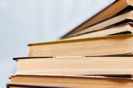 stack of old book on wooden table, education concept background, many books piles with copy space...