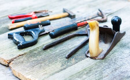 Set of vintage hand construction and carpentry tools hammers on a old wooden background, retro...