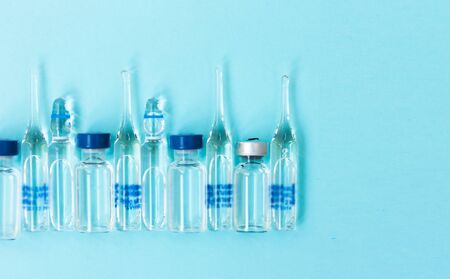 injection ampoules for vaccination on a blue background, healthcare coronavirus, cancer, painand treatment, pharmaceutical medicine conceptの写真素材
