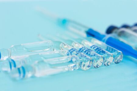 injection ampoules, syringe for vaccination on a blue background. healthcare and medicine conceptの写真素材