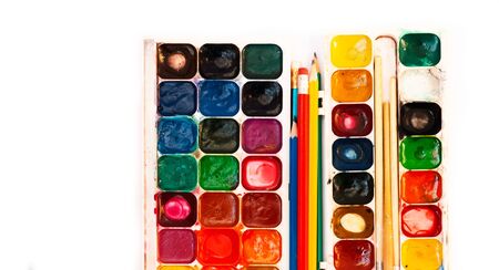 paint, brushes, pencils well used on white background. Back to school, home schooling conceptの写真素材