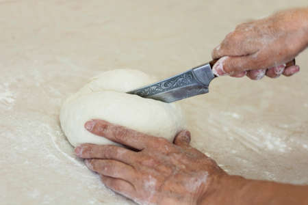 women's hands kneading making dough for dumplings.