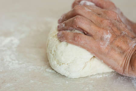 women's hands kneading making dough for dumplings.