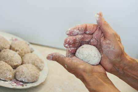 homemade meatballs - female hands make minced meatballs - traditional Italian cuisine