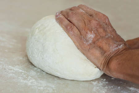 women's hands kneading making dough for dumplings.の写真素材
