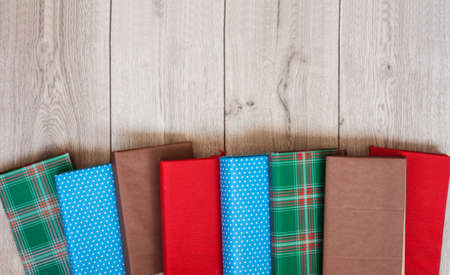 Books textbook in colorful covers on a wooden background. Back to school distance home...