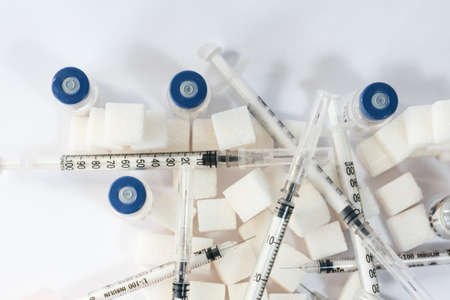 Sugar addiction, insulin resistance, unhealthy diet, sugar cubes pyramid, bottles of insulin and...