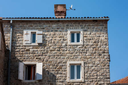 Street and landscape of Old town Budva, Montenegro: medieval city, ancient walls and red tiled roof, beautiful viewの写真素材