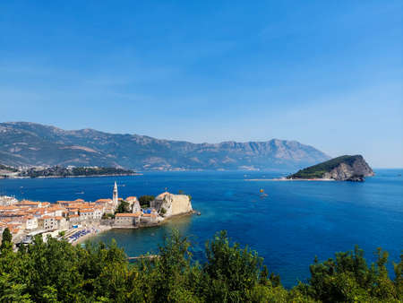 The view of St. Nicholas Island and Budva medieval fortress of St. Mary, Citadel, landscape of Old town Budva, Montenegro, beautiful seascapeの写真素材