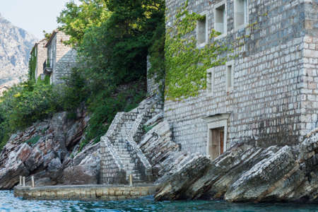 beautiful view, dock stairs of island Sveti-Stefan near Budva in Montenegro, Europe, Adriatic Sea and mountainsの写真素材