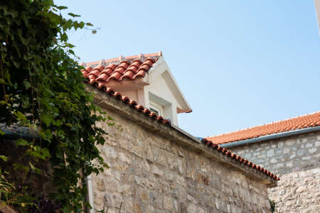 Street and landscape of Old town Budva, Montenegro: medieval city, ancient walls and red tiled roof, beautiful viewの写真素材