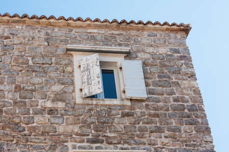 Street and landscape of Old town Budva, Montenegro: medieval city, ancient walls and red tiled roof, beautiful viewの写真素材