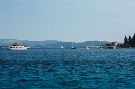 Bay of Kotor, view from the sea to the boats near old town of Herceg Novi in Montenegro, Europe, Adriatic Sea and mountainsの写真素材