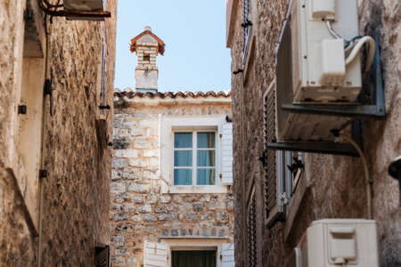 Street and landscape of Old town Budva, Montenegro: medieval city, ancient walls and red tiled roof, beautiful viewの写真素材