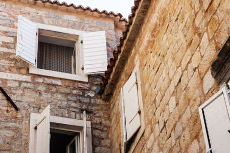 Street and landscape of Old town Budva, Montenegro: medieval city, ancient walls and red tiled roof, beautiful viewの写真素材