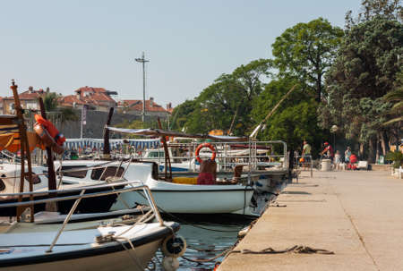 Budva, Montenegro - August 15 2021: city port with pleasure boats, fishing boats and yachts near the old town of budvaのeditorial素材
