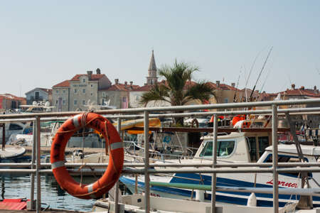 Budva, Montenegro - August 15 2021: city port with pleasure boats, fishing boats and yachts near the old town of budvaのeditorial素材