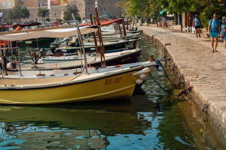 Budva, Montenegro - August 15 2021: city port with pleasure boats, fishing boats and yachts near the old town of budvaのeditorial素材