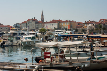 Budva, Montenegro - August 15 2021: city port with pleasure boats, fishing boats and yachts near the old town of budvaのeditorial素材