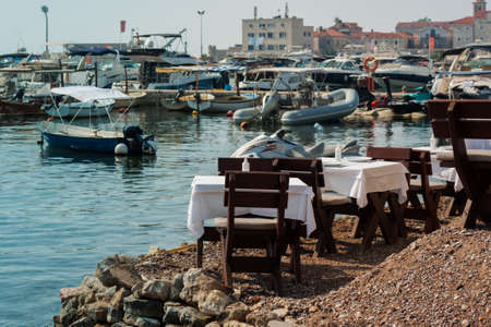 Budva, Montenegro - August 15 2021: city port with pleasure boats, fishing boats and yachts near the old town of budvaのeditorial素材