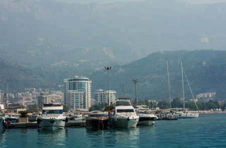 city port with pleasure boats, fishing boats and yachts near the old town of Budva, Montenegro, Adriatic seaの写真素材