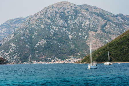 Bay of Kotor, view from the sea to the boats near old town of Herceg Novi in Montenegro, Europe, Adriatic Sea and mountainsの写真素材