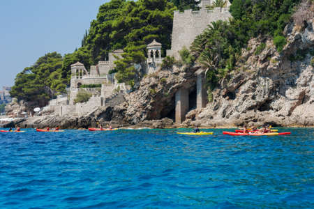 Adriatic Sea near Dubrovnik, Croatia - August 13 2021: people on kayaking boats near the coastのeditorial素材